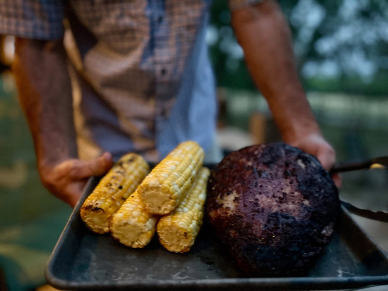 Smoked roast with grilled corn on a backyard tray